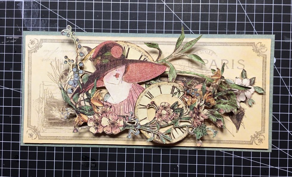 Next layer, fussy cut lady then smaller clock as shown. Now locate flower branch and layer over the top as shown.