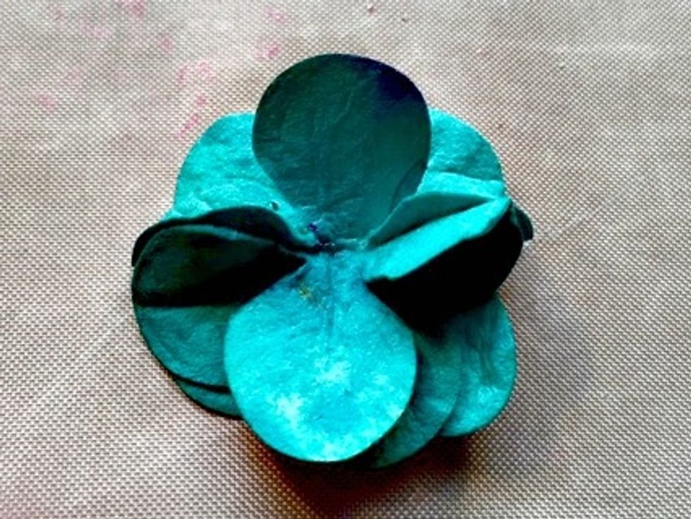 Next layer take two more blooms and do the same thing folding in half and gluing to the top. Stagger the petals also.