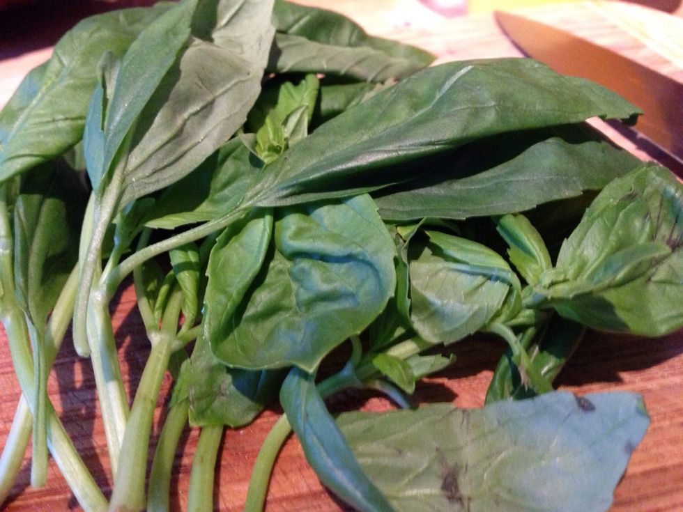 Next let's grab and wash the basil. Take a quarter of the bunch and slice thinly.