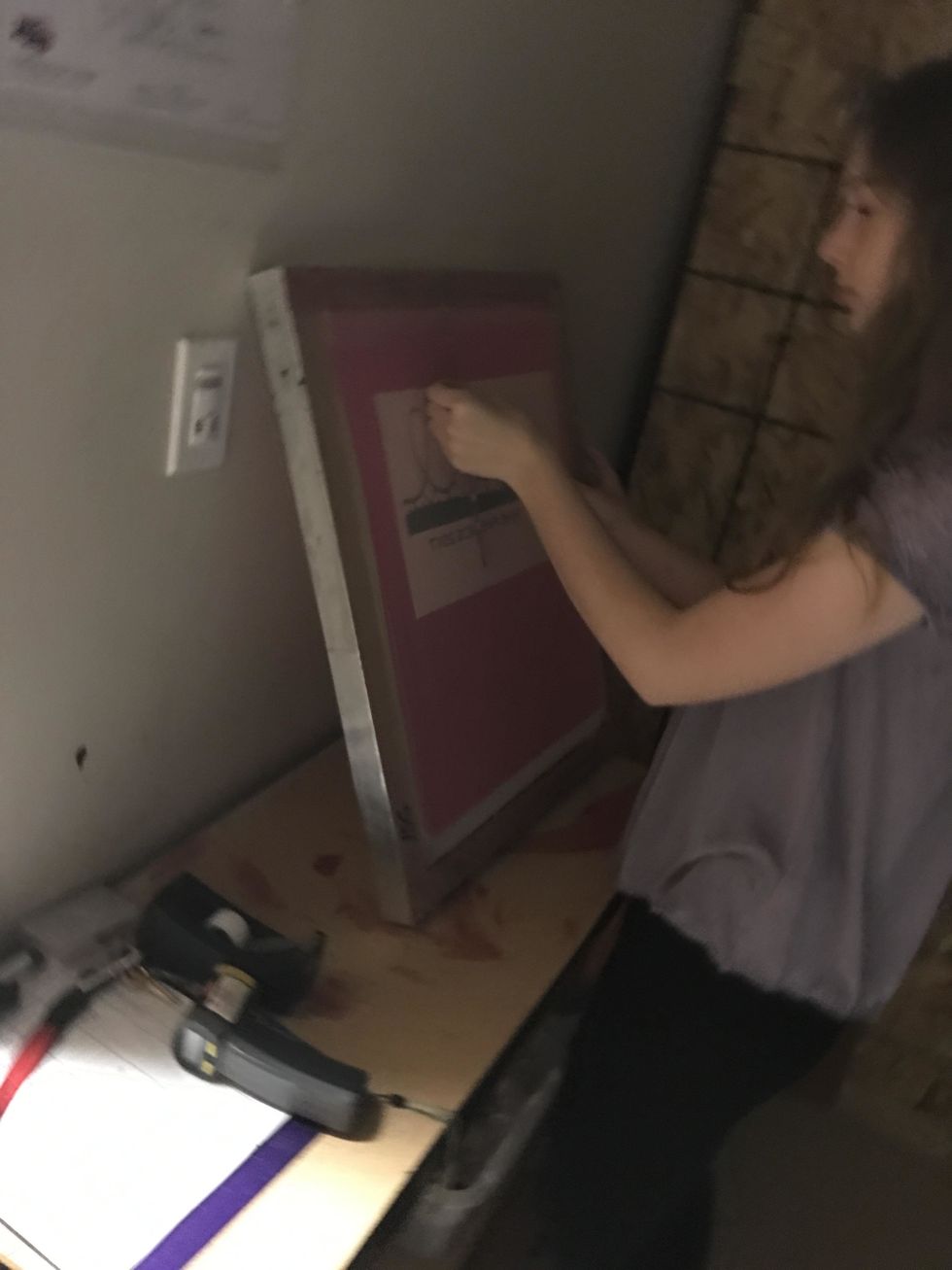 Next, line up the vellum to the back of the screen. Use t-squares to make sure the design is centered. Tape corners of design after it is lined up. Be careful because the screens are light sensitive.