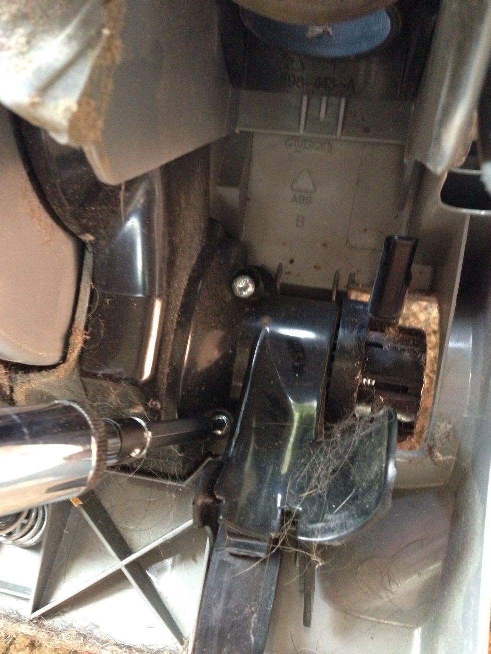 Next locate the three screws on the black housing that covers the clutch that you're trying to get at. You'll need that T15 screwdriver for this. The third one is accessed from the top deep in a hole.