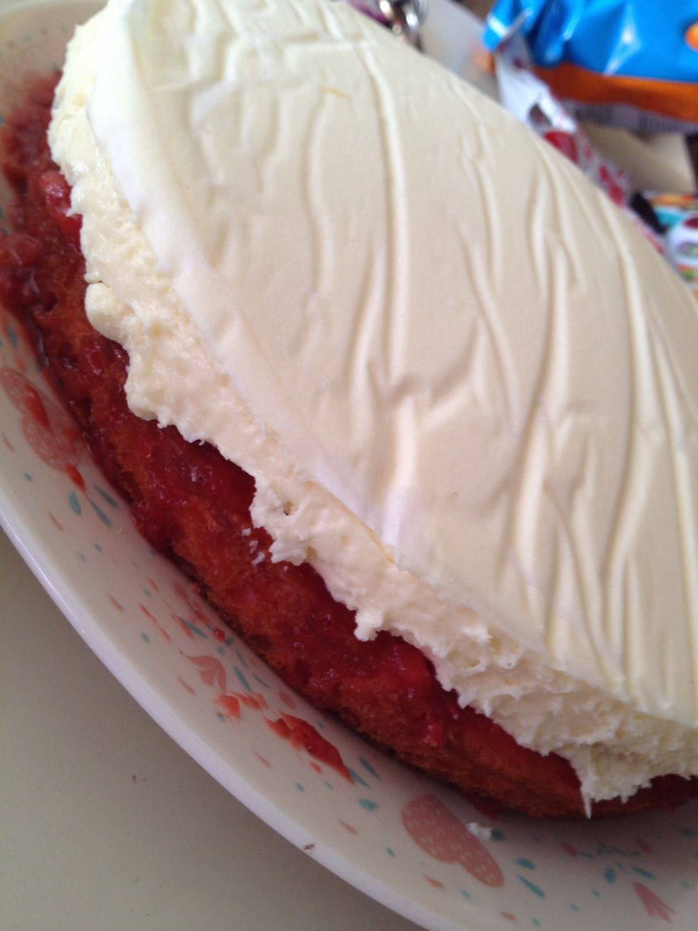 Next, loosen up your cheesecake and place on top of your first layer of cake.