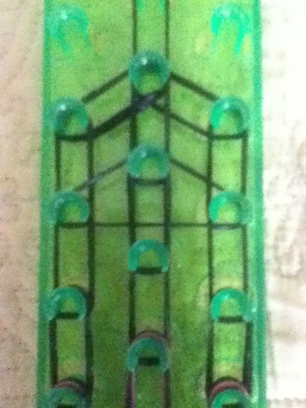 Next make a triangle and rap it around 2 times (if not stretchy use 2 rubber bands) repeat this 2 more times the middle one goes rapped around 3 times