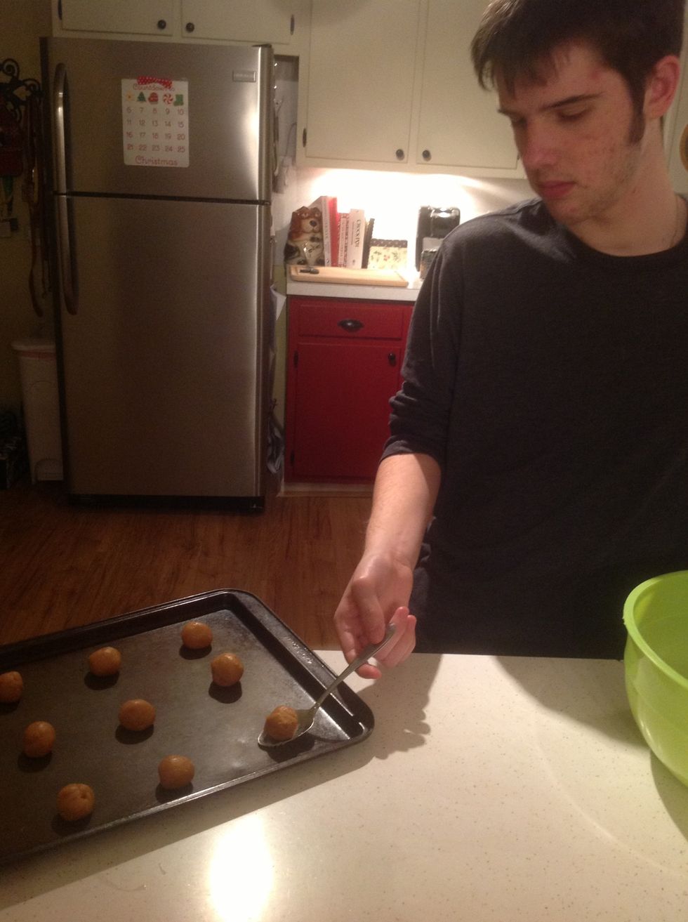 Next, make balls of peanut butter dough no larger than an inch in diameter. These are snack-sized cookies so the balls should not be bigger than I inch. Place the balls on a non-stick cookie sheet.