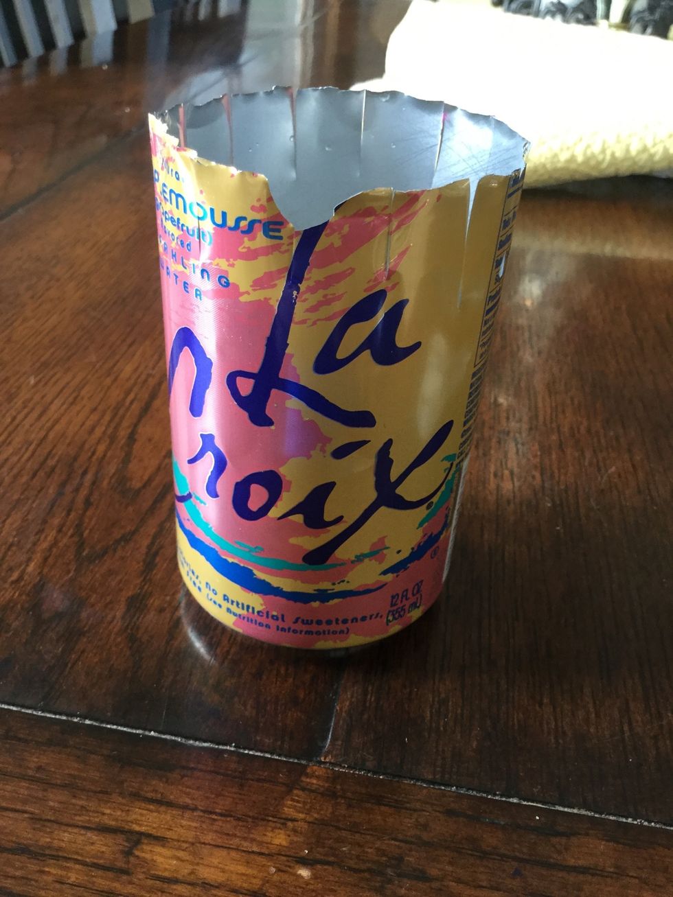 Next make small cuts all around the cans top. The farther down you go the shorter the can will end up. Again, be careful!
