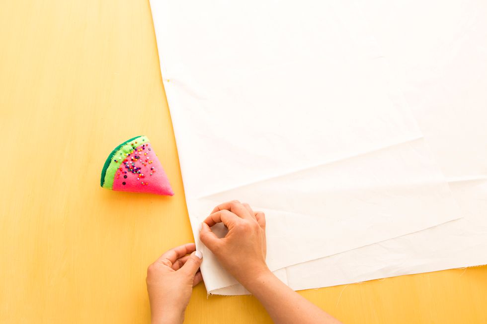 Next, measure the length of the back of your car. Along the shorter length of your fabric, measure two and a quarter feet on either side of the stitch you just made (your middle point).