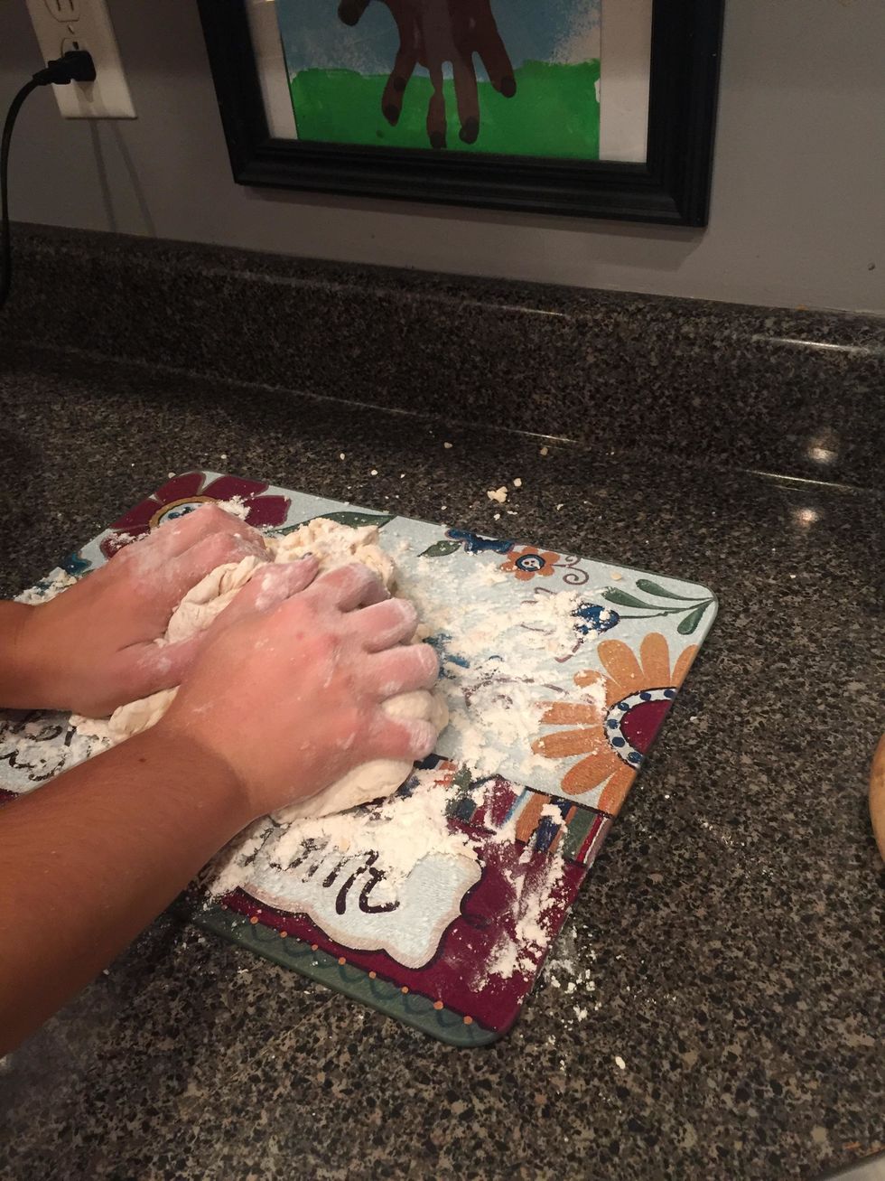 next, move to a flat surface that is lightly covered with flour. begin kneading the dough until it becomes smooth and elastic