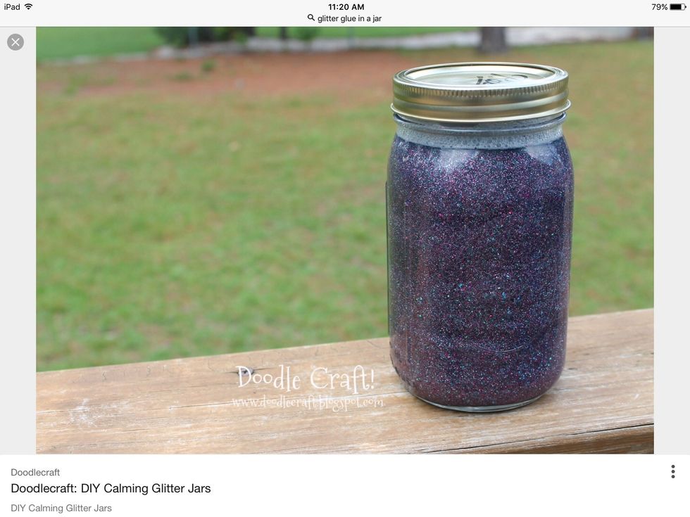 Next, open the lid off the empty water bottle and get some glitter glue and open the lid and pour a little bit of glitter glue in the empty water bottle.