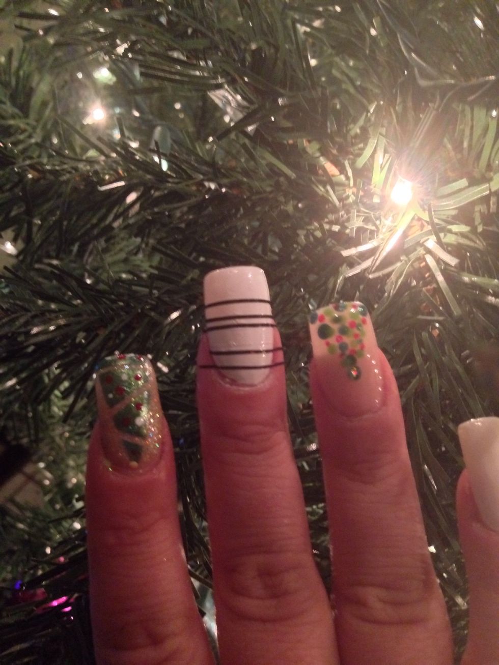 Next paint a nail white, and once it dries take striping tape , and place it across the nail in random areas.