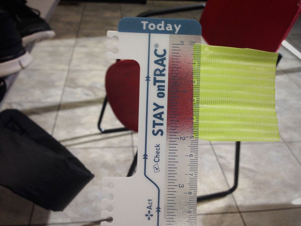 Next, pick the color of duct tape you would like the center of your flower to be and cut a two inch piece of it with your scissors.