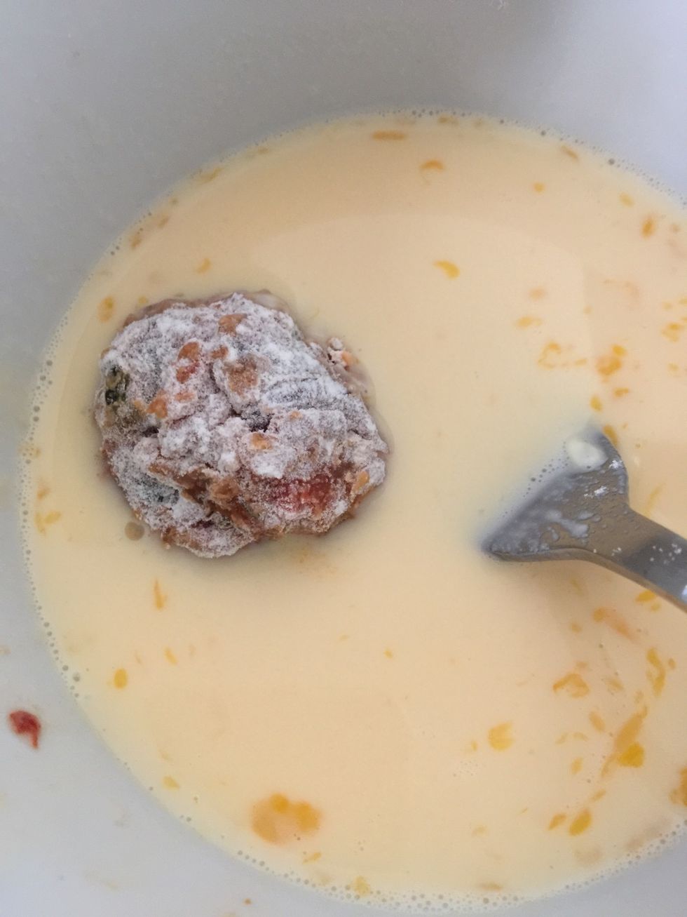 Next place it in egg and milk mix, coat well.