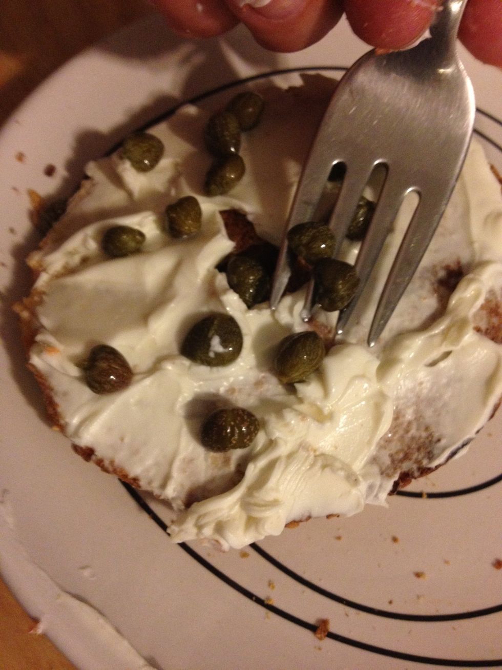 Next place the capers around on the cream cheese. If you choose to use tomato and/or cucumber slices, add those at this point as well.