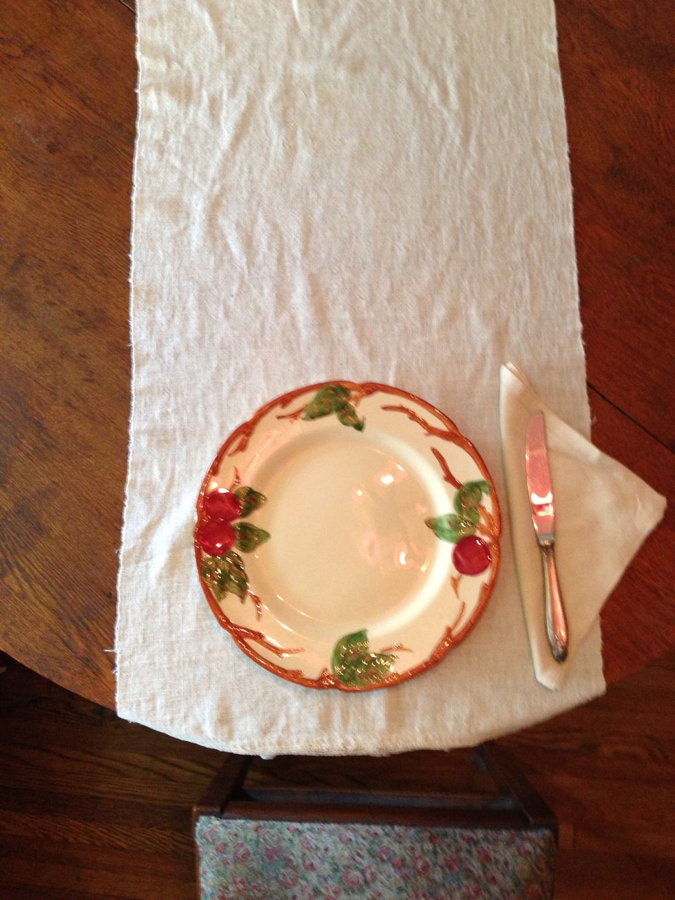 Next, place the knife (with the blade facing the plate) at the right edge of the plate. If you are placing the napkin elsewhere, the silverware would go directly on the cloth.