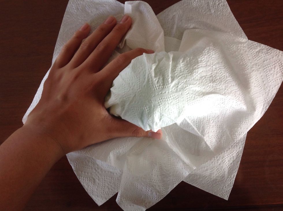 Next place two of your paper towels on the ball and shape it to the form of the ball with both hands.