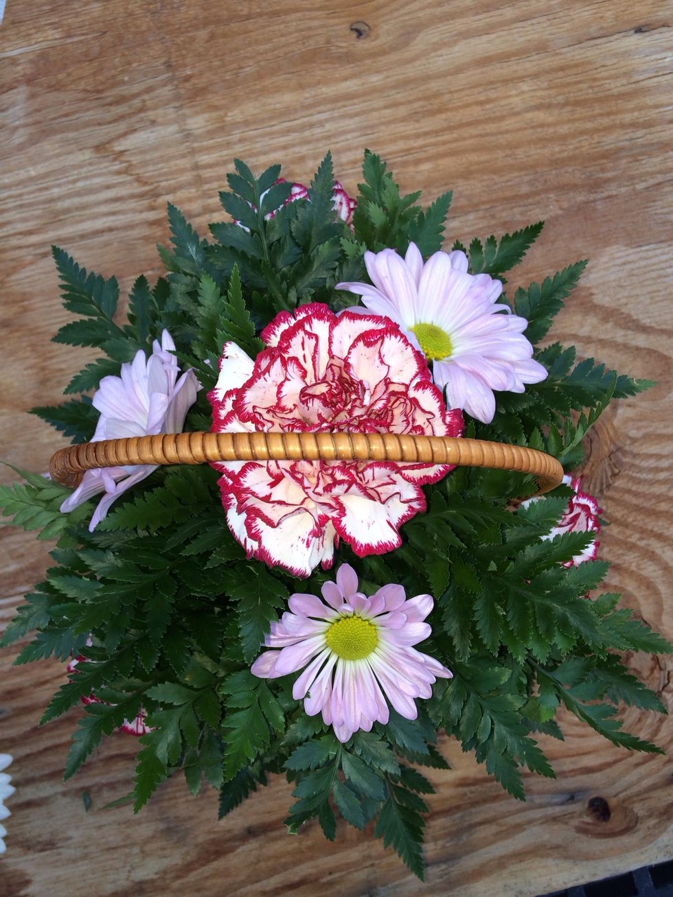 Next place your 3 purple daisies towards the top in between the carnations at the bottom.