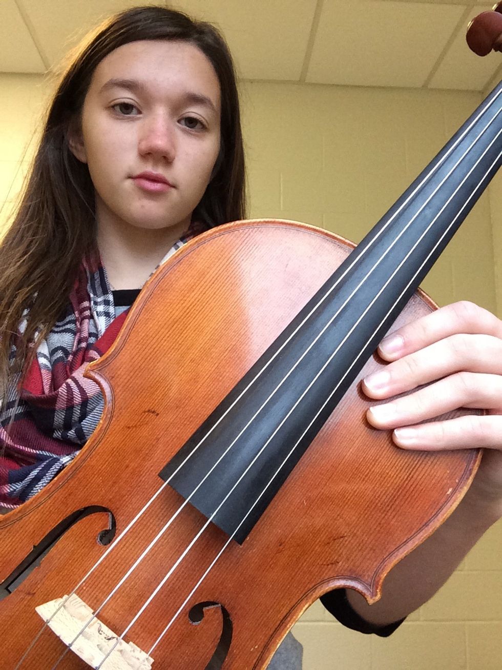 Next, place your left hand on the body of the viola.