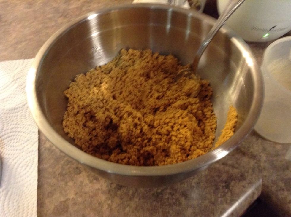 Next poor your graham cracker crumbs and the butter in the mixing bowl and stir