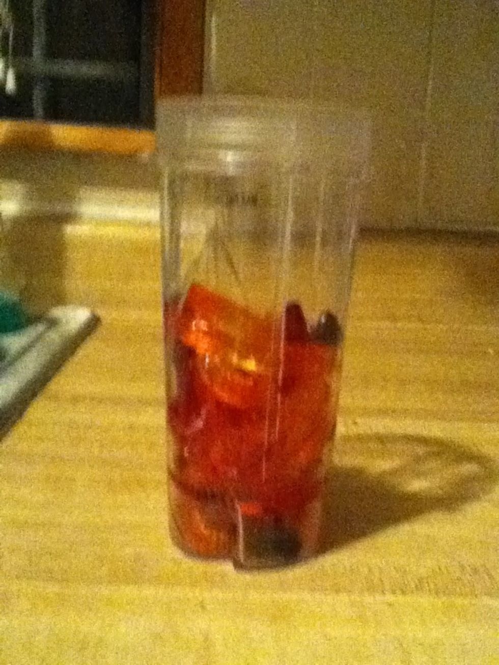 Next pour all of the gummy worms into plastic cup