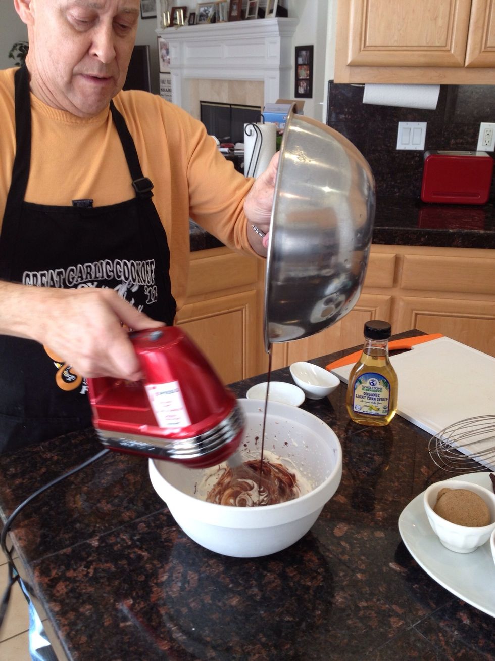 Next, pour in the chocolate ganache and fold in with the whisk.