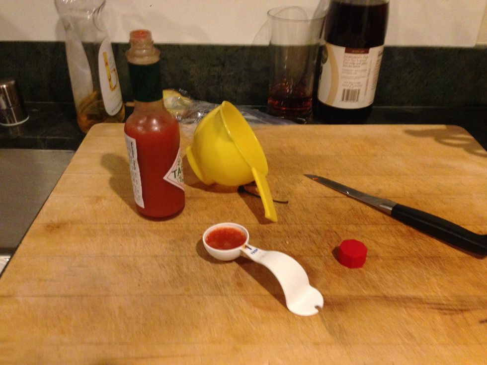 Next, pour out one teaspoon of Tabasco and pour it into your blender.