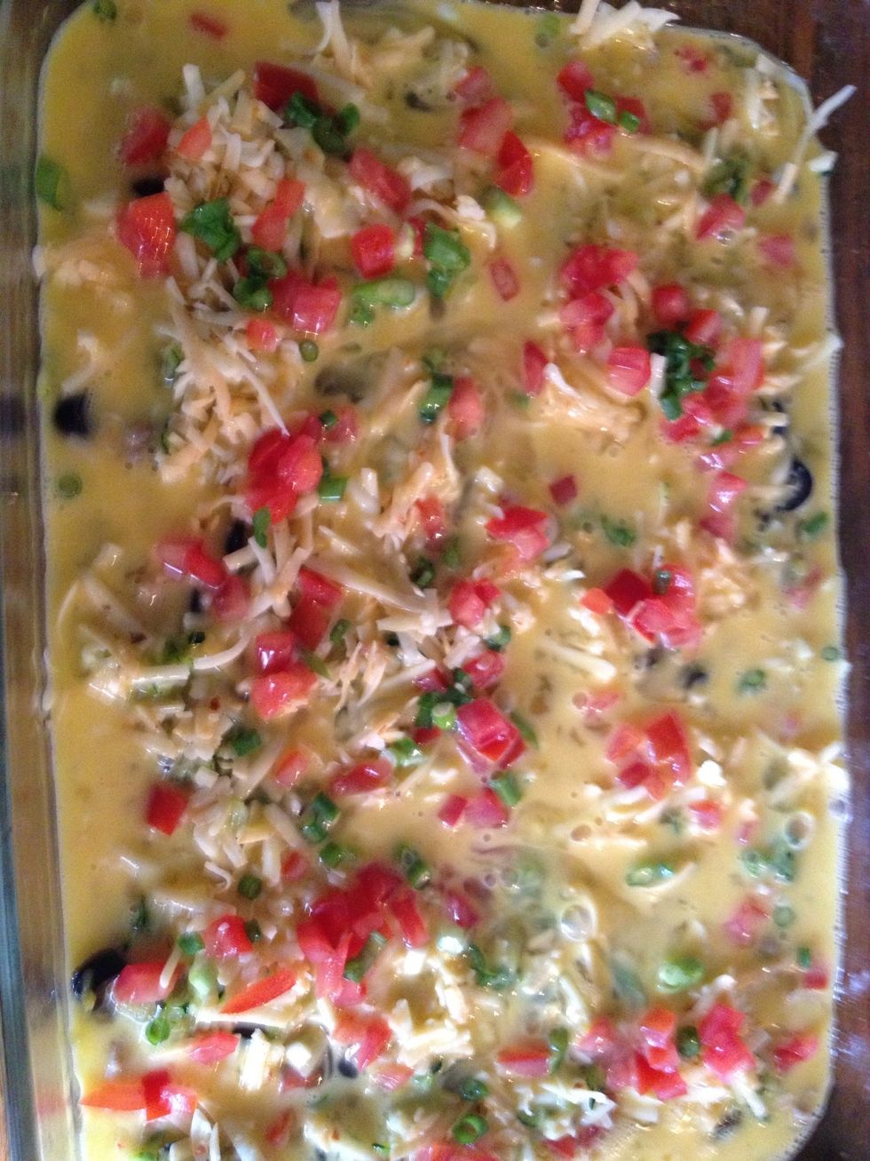 Next, pour your scrambled eggs evenly around dish. Use a rubber spatula to work the eggs into the nooks and crannies.