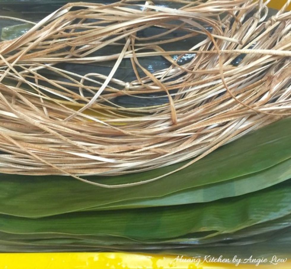Next prepare the bamboo leaves by first boiling them for 5 to 10 minutes. Then rinse gently with water and leave to soak overnight together with bamboo strings.
