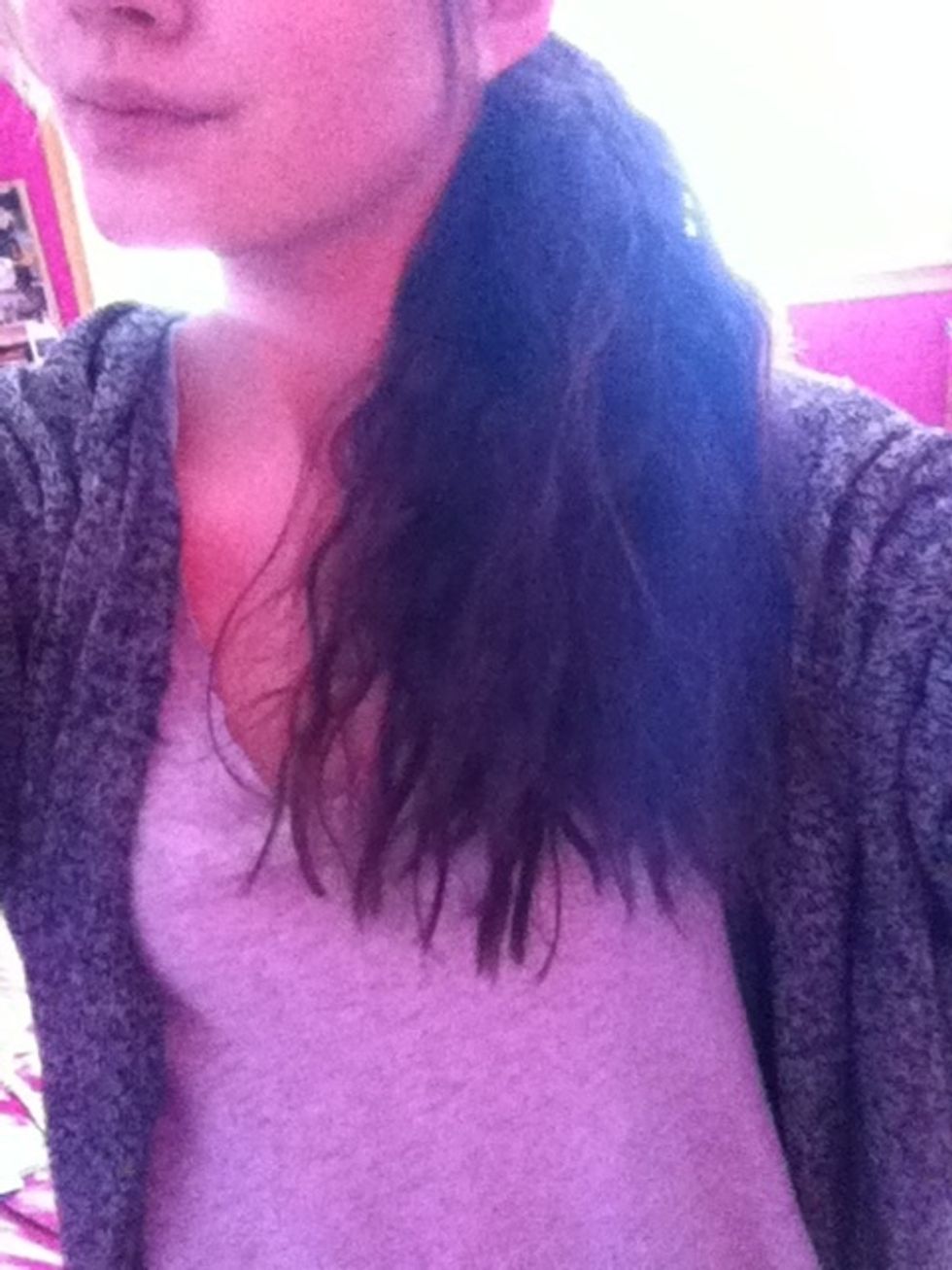 Next, pull into a low side ponytail on one side of your head and secure with an elastic.