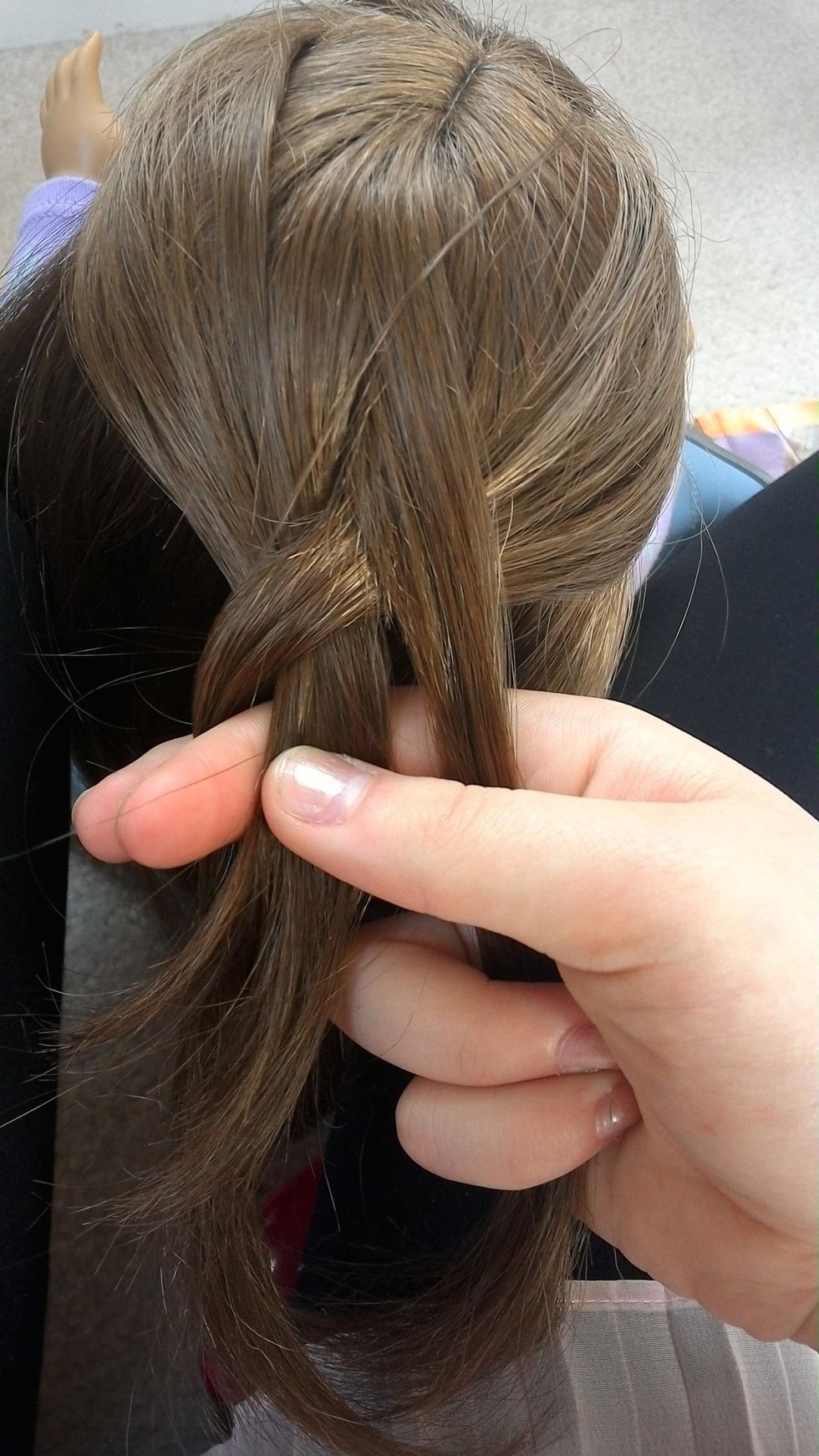 Next pull it under the strand that is in the middle.