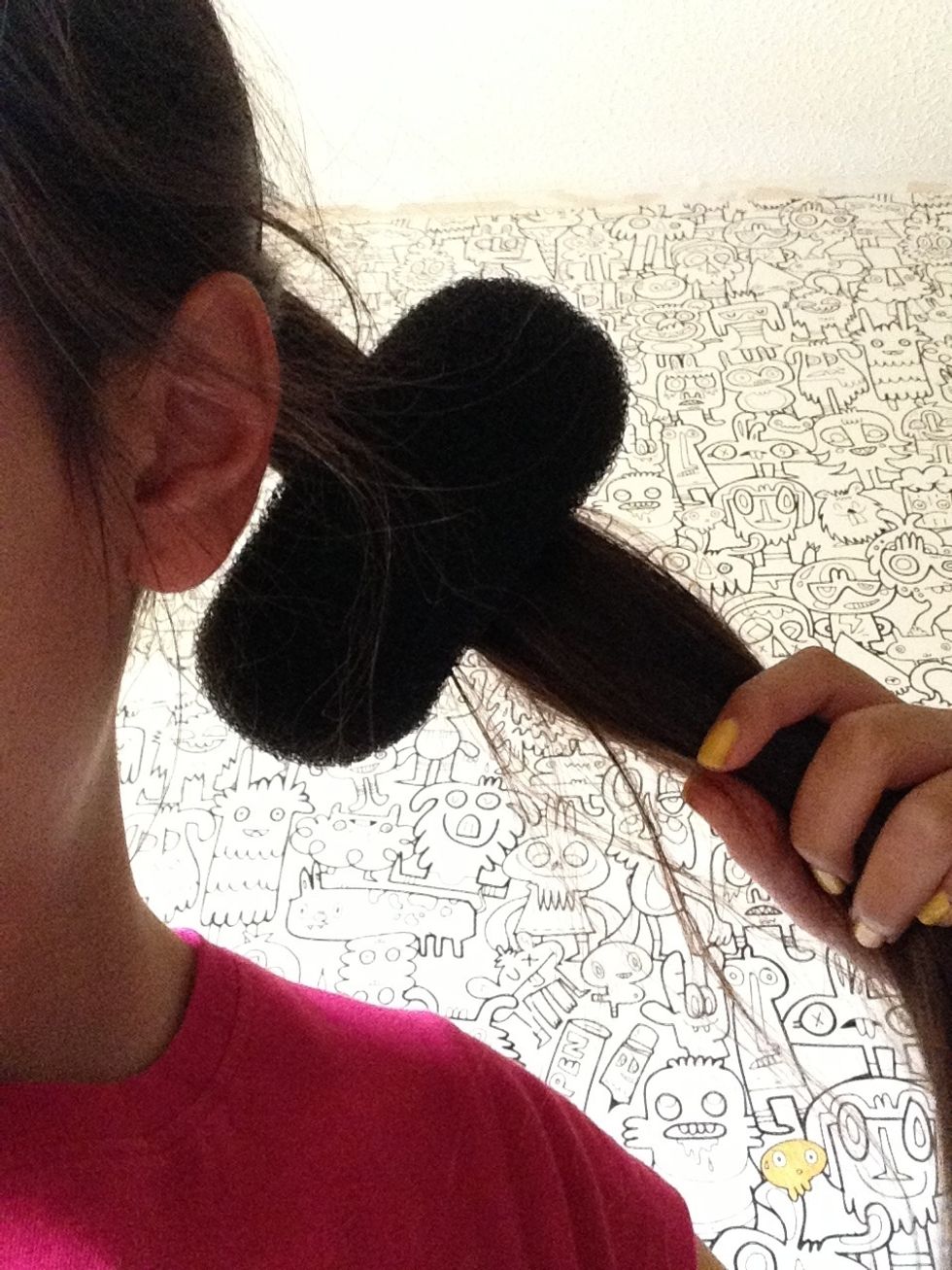 Next, pull the dough nut through the pony like this.