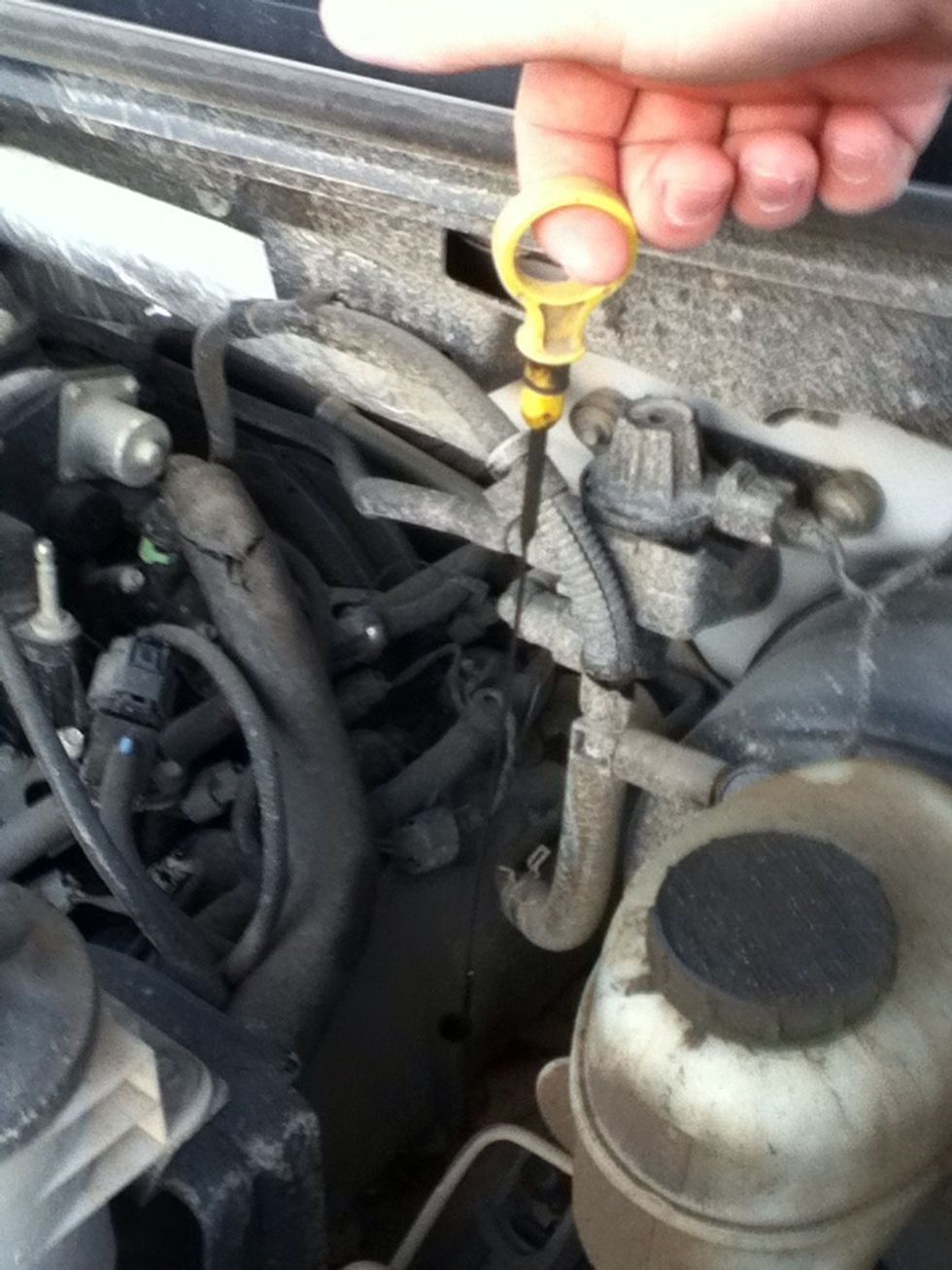 Next, pull the oil stick out for its hole.