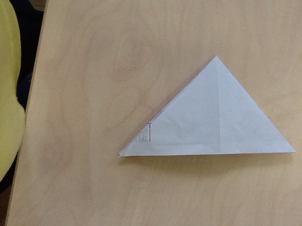 Next,  pull the paper in triagal in the both side.