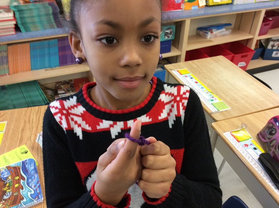Next pull the string around your finger and pull it to make the first not