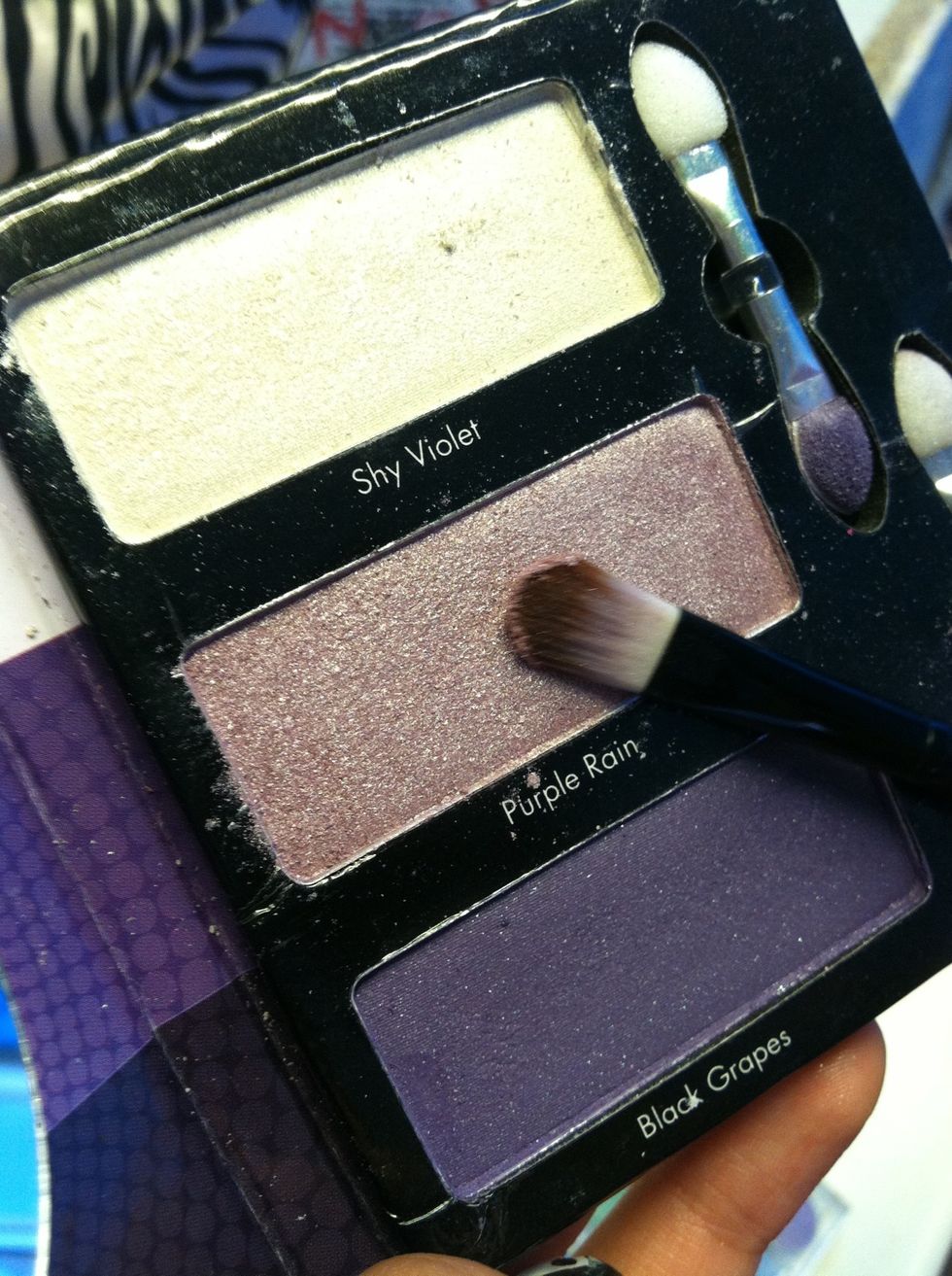 Next put a slightly darker purple under the brow line (the brow line is under your eyebrow)