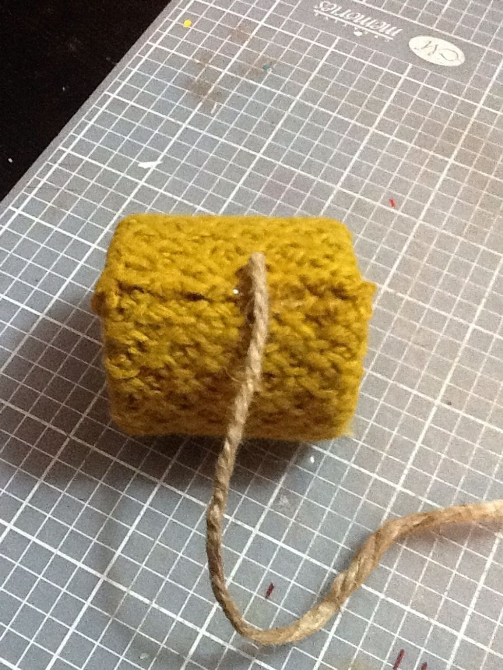 Next, put a tiny drop of hot glue where the fabric ends meet and press the jute into the glue.