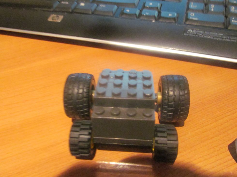 Next put the axle with wheels on the very front.