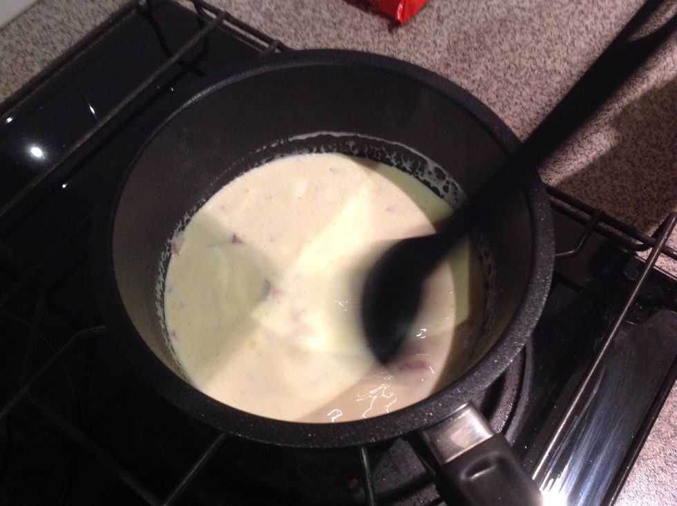 Next, put the cream in with the bacon and cook it.