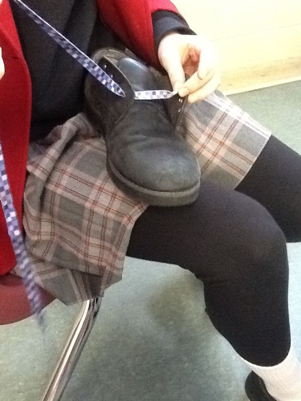 Next: put the shoelace in the bottom right whole, but remember put in from the outside