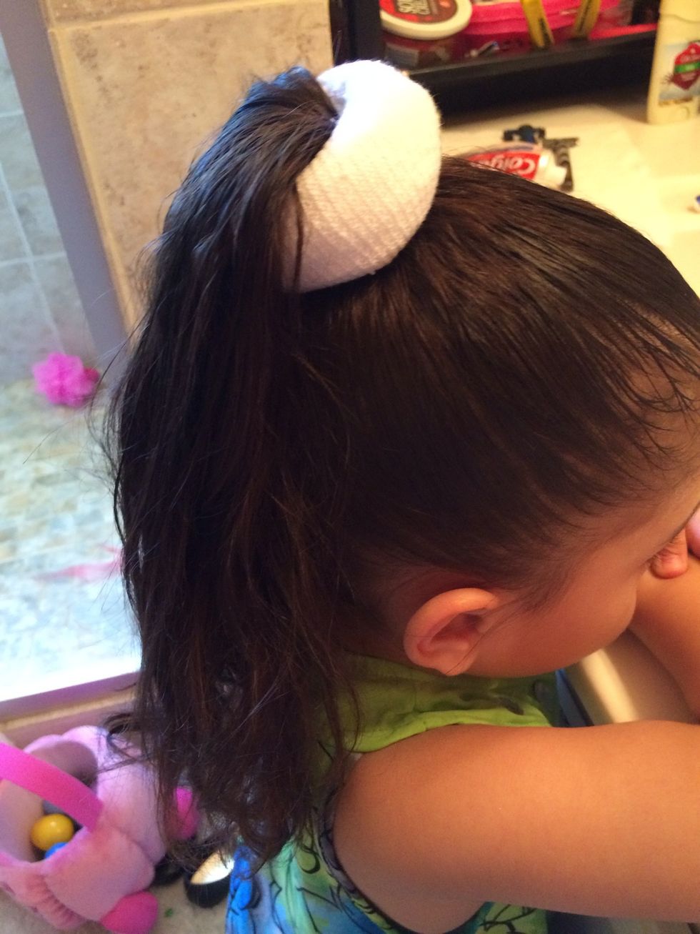 Next ,Put the sock or donut through your hair