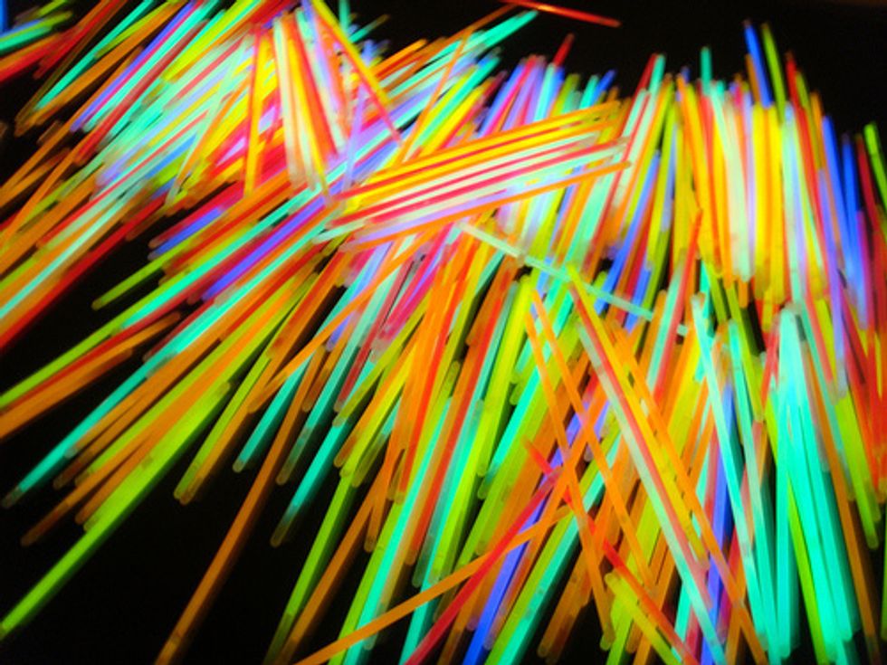 Next, put your gloves on, take one glow stick, snap it in half and put all the stuff in the jar.