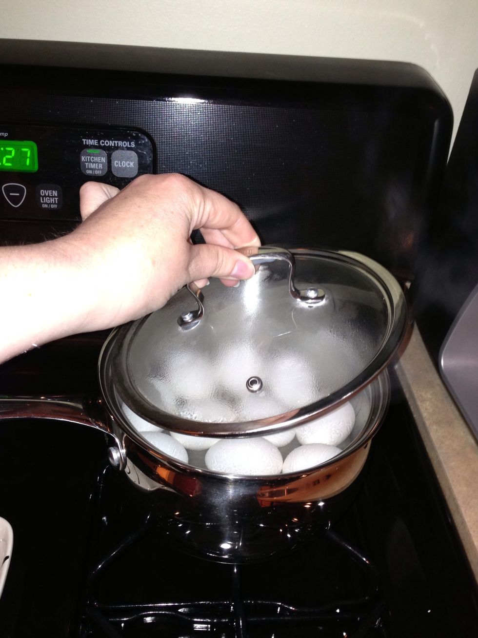 Next, remove the pan from the heat and cover the eggs. They will continue to cook in the hot water.