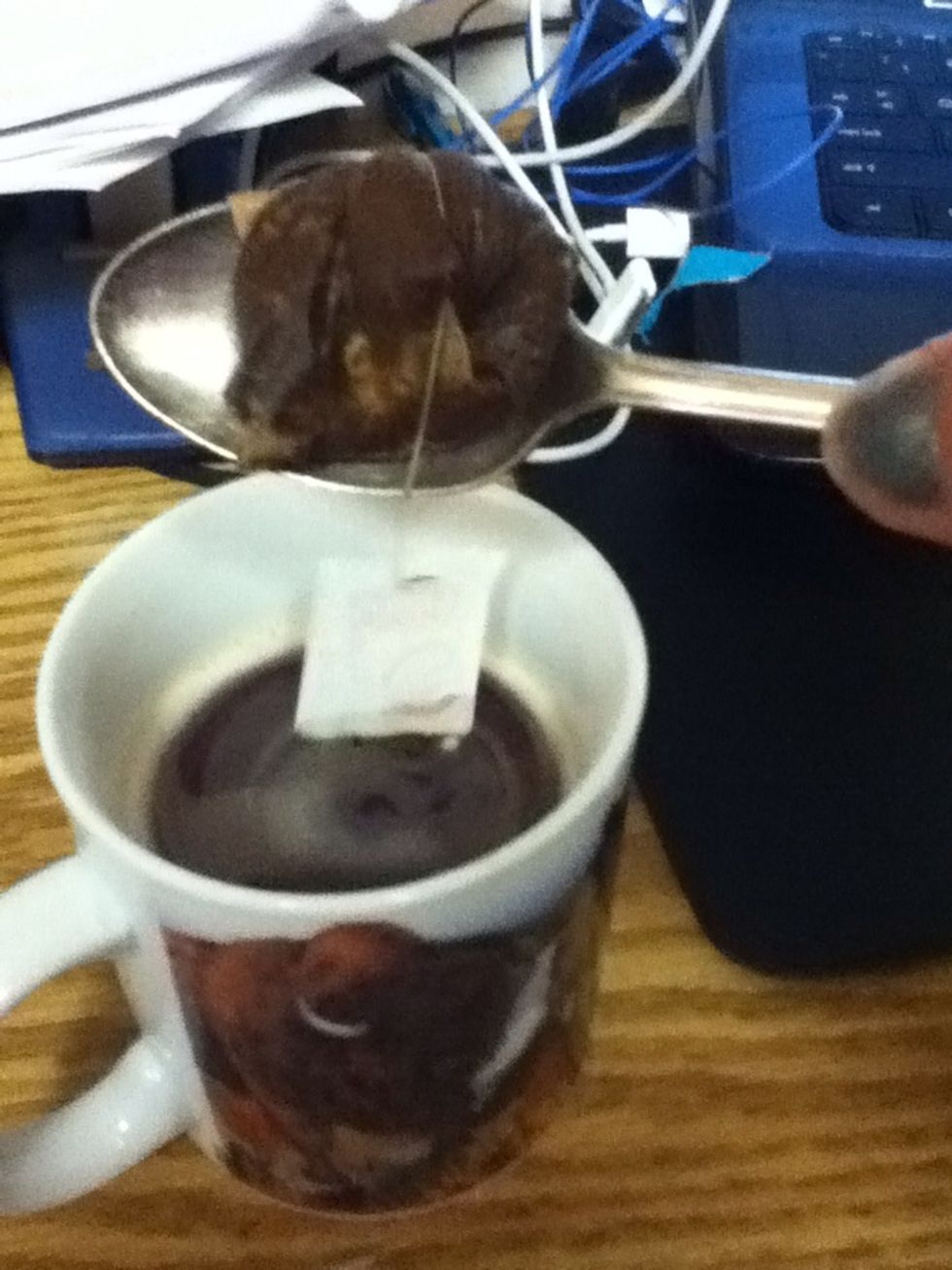 Next, "ring out" the tea bag on the spoon; you don't want to waste all that great tea. This has to be done after the sugar so the spoon isn't wet when it goes into the sugar.