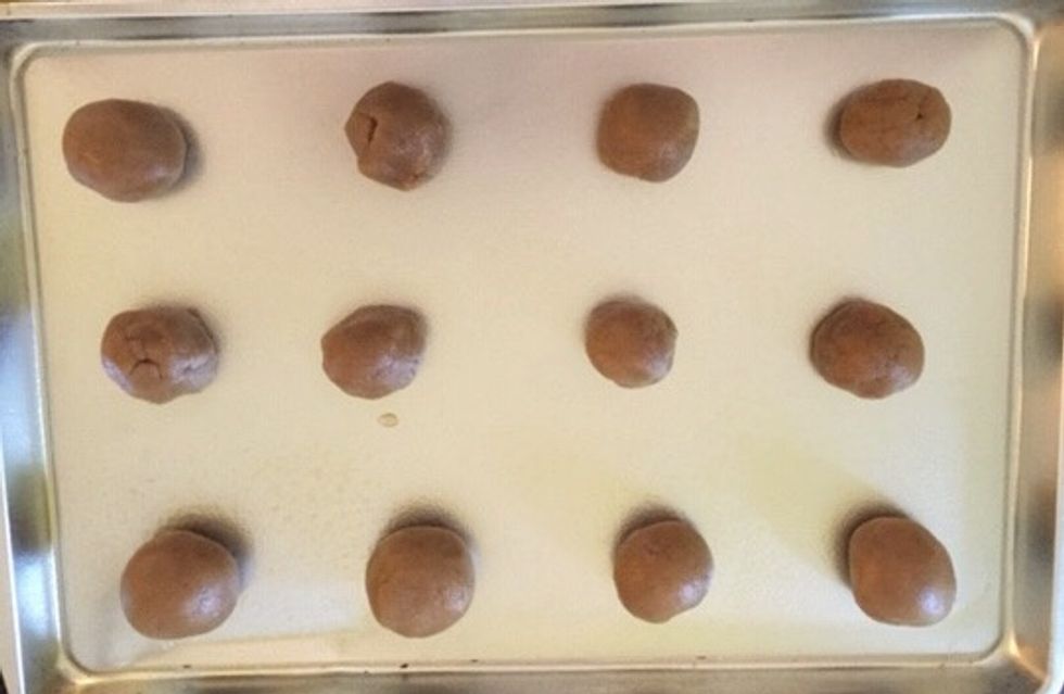 Next roll the batter into small ball shapes and place on greased cooking sheet.