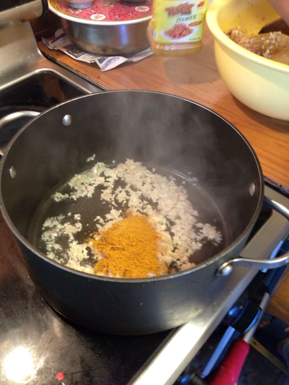 Next, saute the rest of the lemongrass, garlic, and shallots over high heat and add 3 more tbsp of curry powder