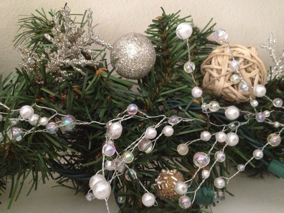 Next, scatter in some glitter decor for sparkle. I use a box of glittery twigs, balls, and beads from Michael's.