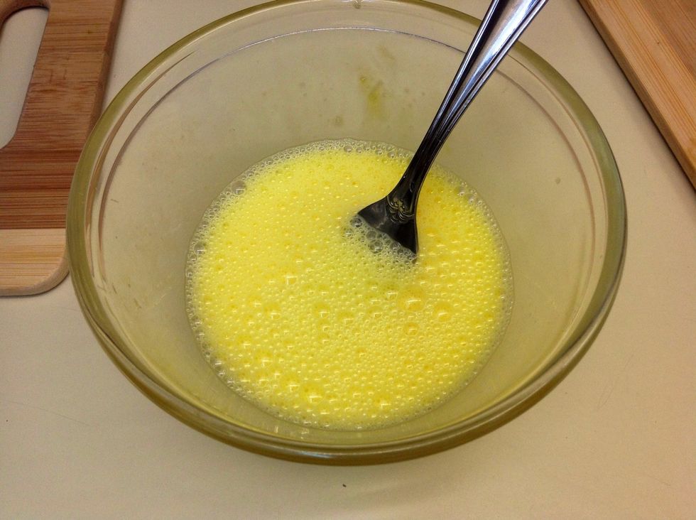 Next scramble your two eggs in a small mixing bowl and add just a little bit of water along the way to make them extra fluffy! Whisk for approximately 15 seconds to get a nice frothy top.