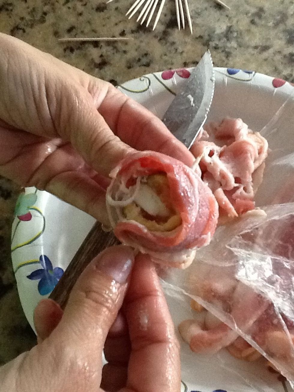 Next, slice your bacon in quarters or thirds, depending on how large your figs are. Wrap one bacon piece around each fig, securing it with the toothpick.