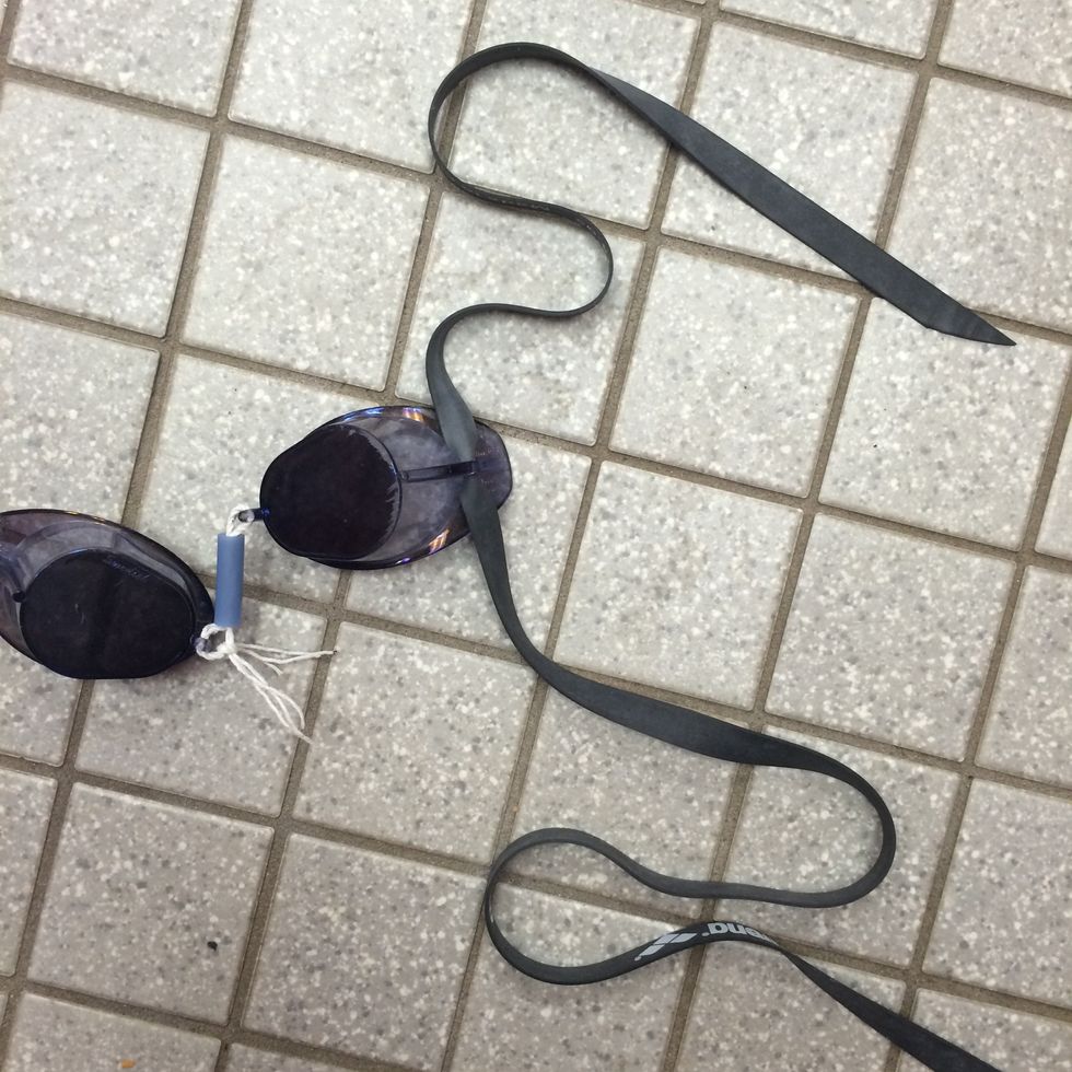 Next, slide one end of the goggle strap through one of the goggles.