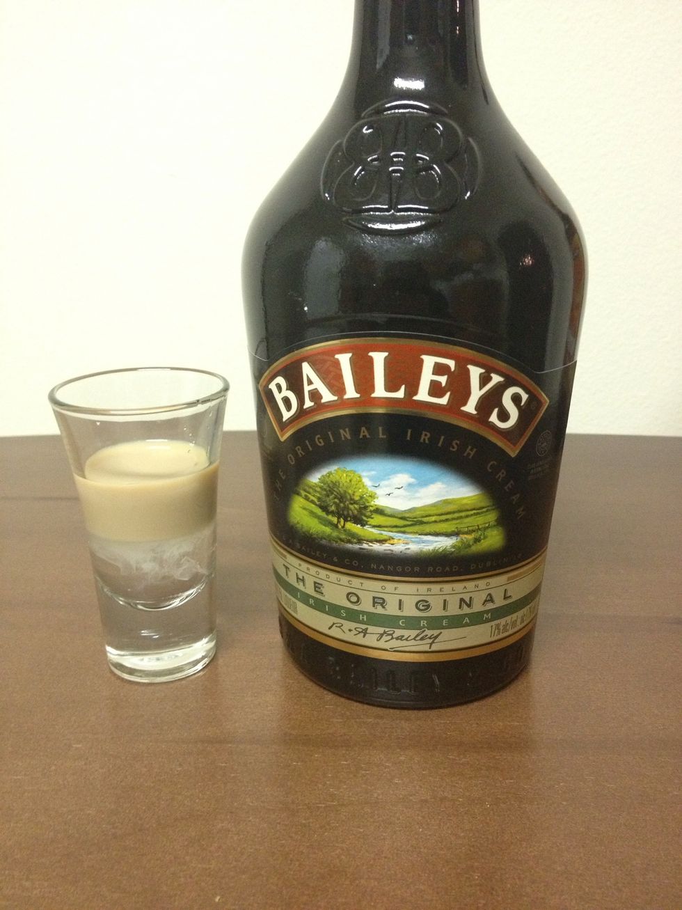 Next, slowly pour in an ounce of your favorite Irish Cream liqueur. It should float. :)