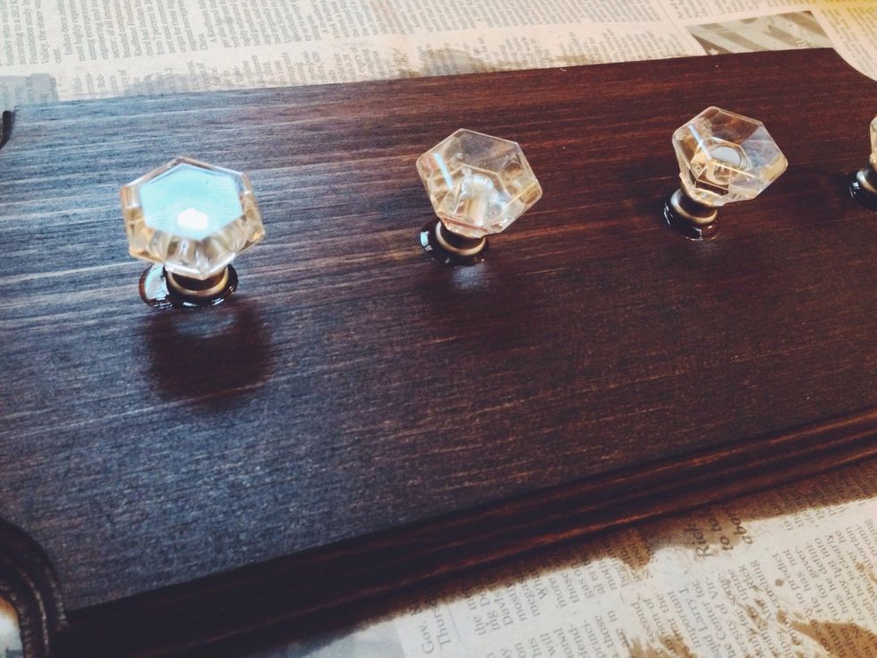 Next, space out your knobs based on how many you have and the size of your block. If you have a drill, go nuts! then screw on your knobs are you are good to go.