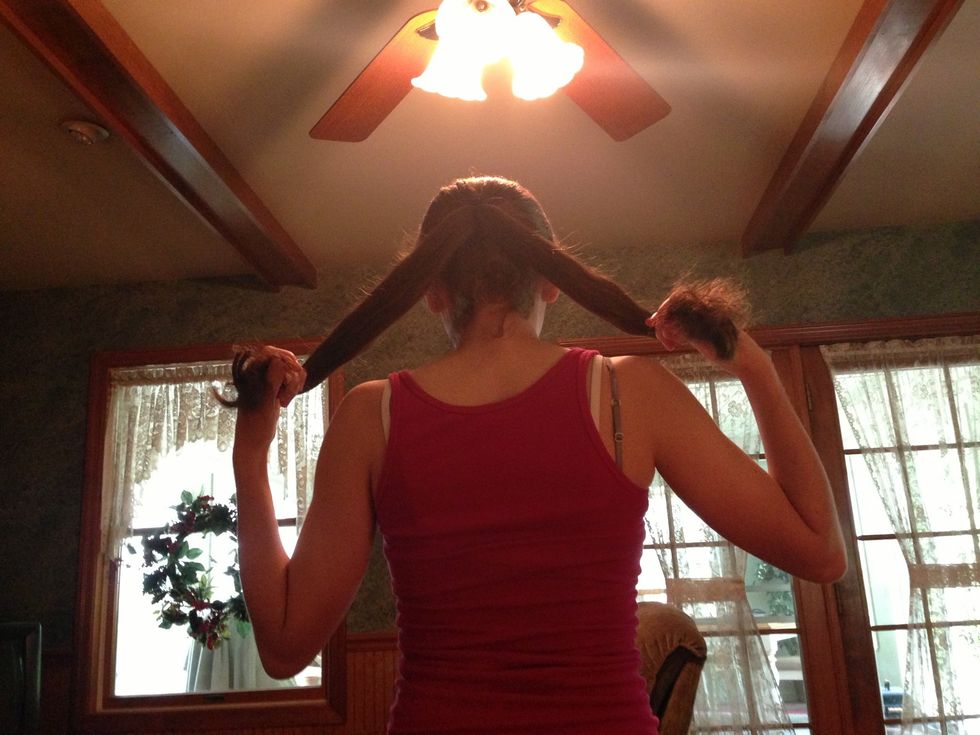 Next split your ponytail into two pieces.